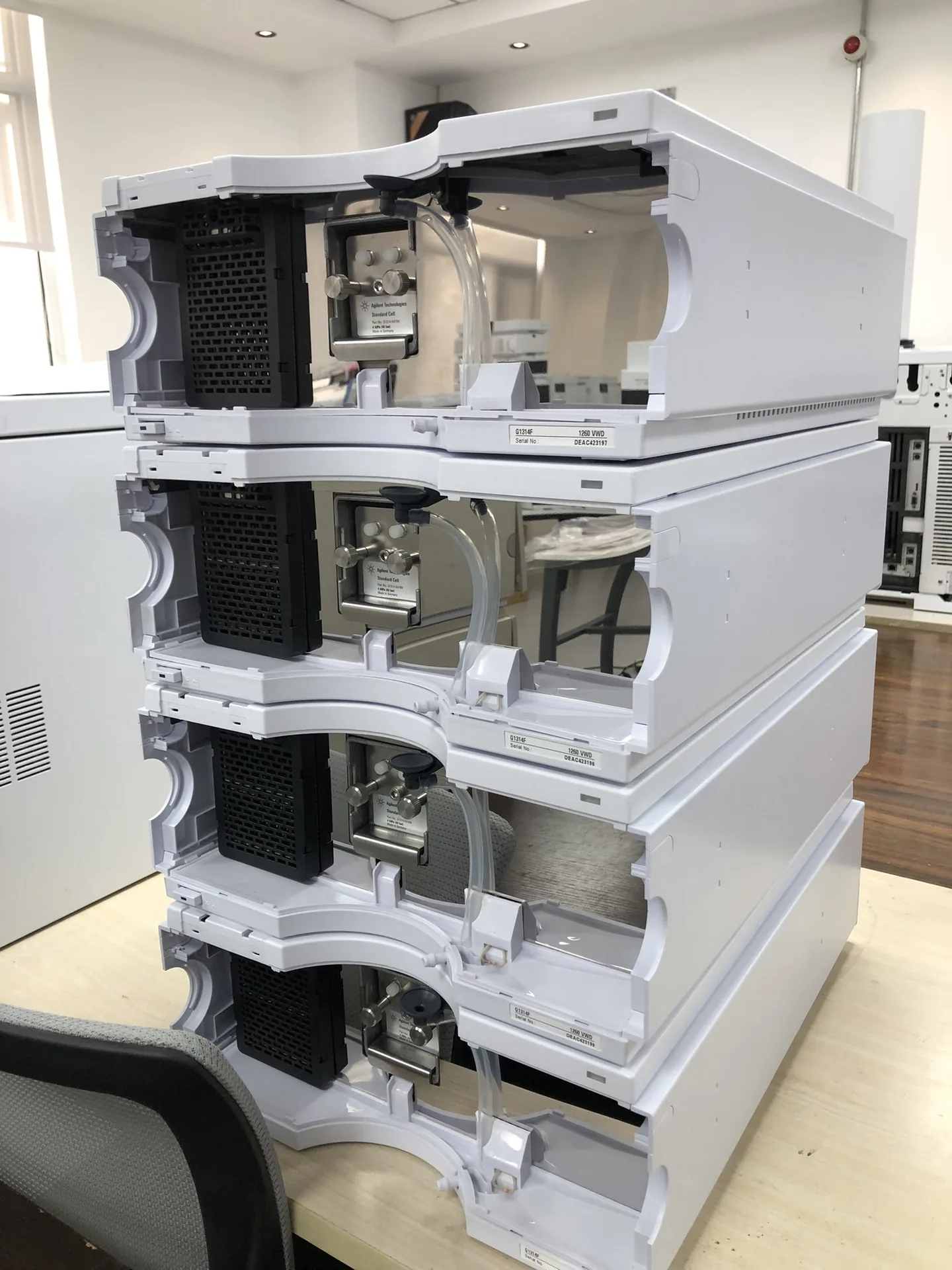 Refurbished Agilent 1260 G1314F VWD modules stacked with covers opened