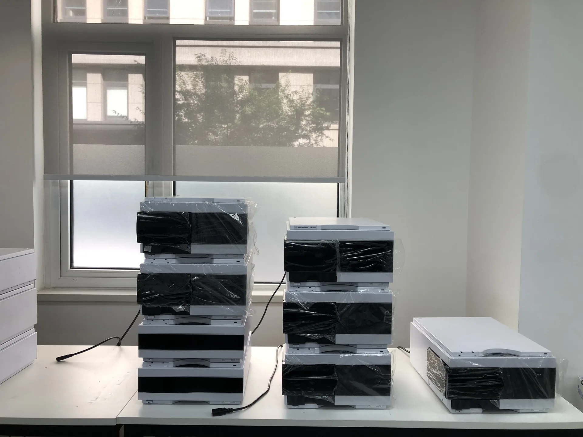 Refurbished Agilent LC module stacks wrapped and packed for delivery